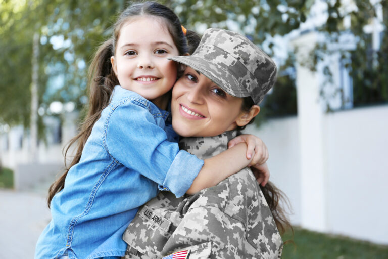 Mother in army uniform and daughter in the street