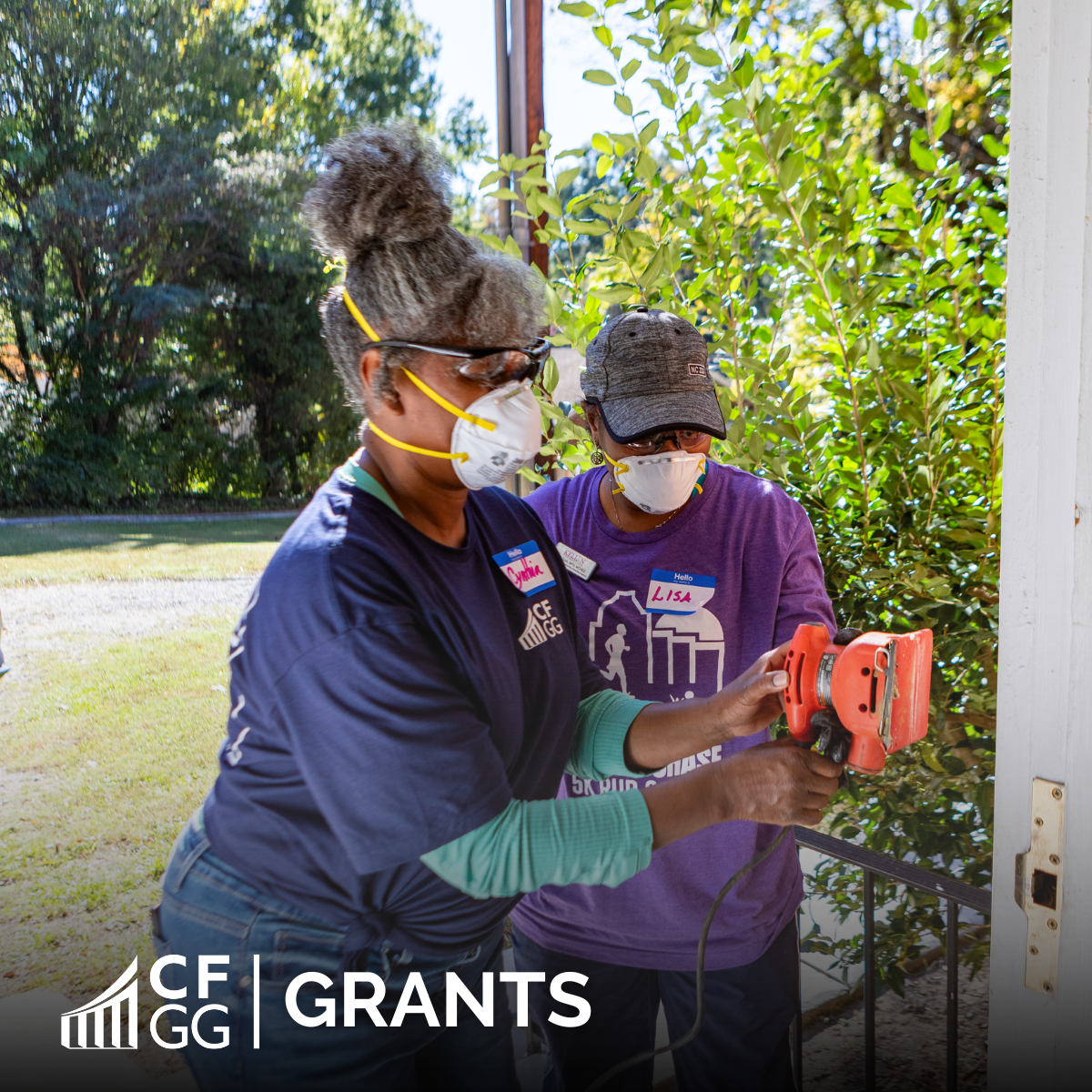 Team member Cynthia Tyler and past Board member Lisa Franklin sanding door at the Kellin Foundation on Community Service Day